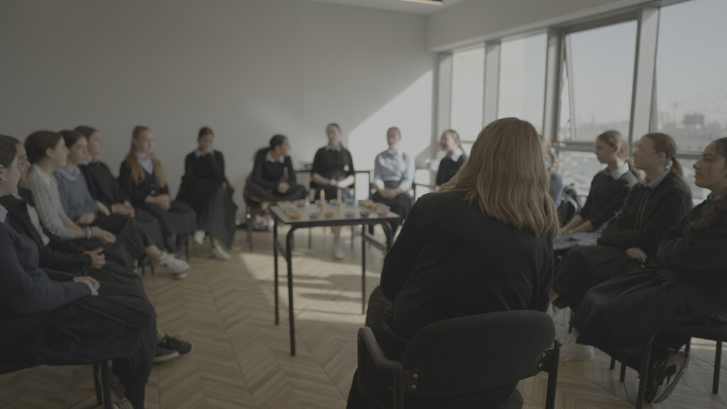 Girls sitting in a circle in a classroom